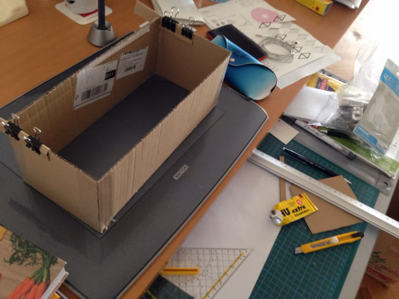 Cardboard prototype of the planter on a work desk